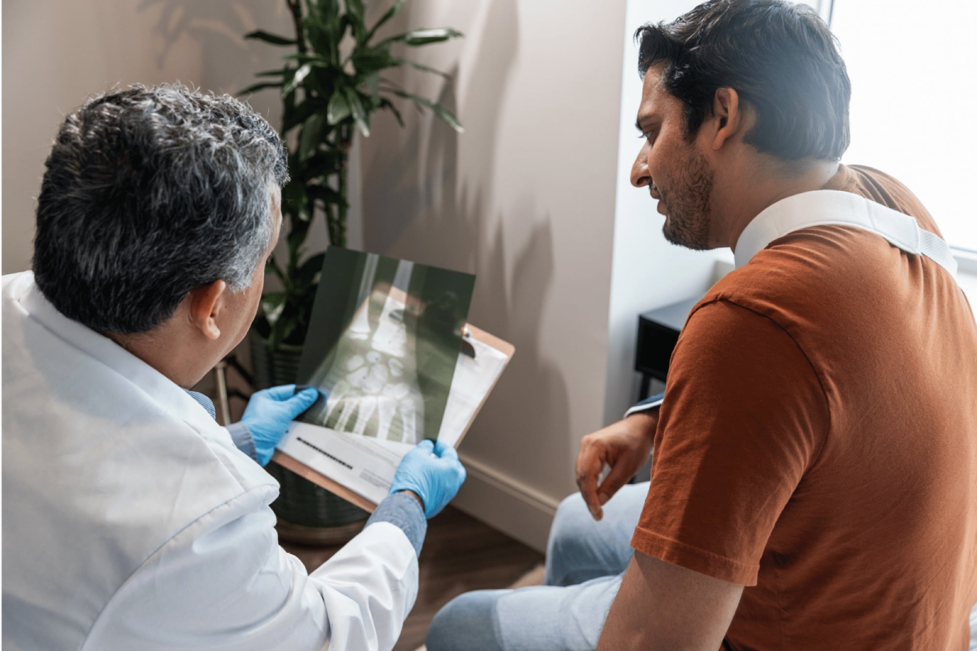 A specialist reviewing imaging with a patient